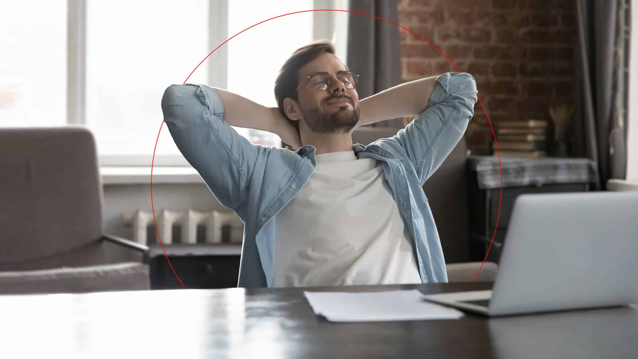 Relaxed guy sitting at desk as phone calls are being blocked