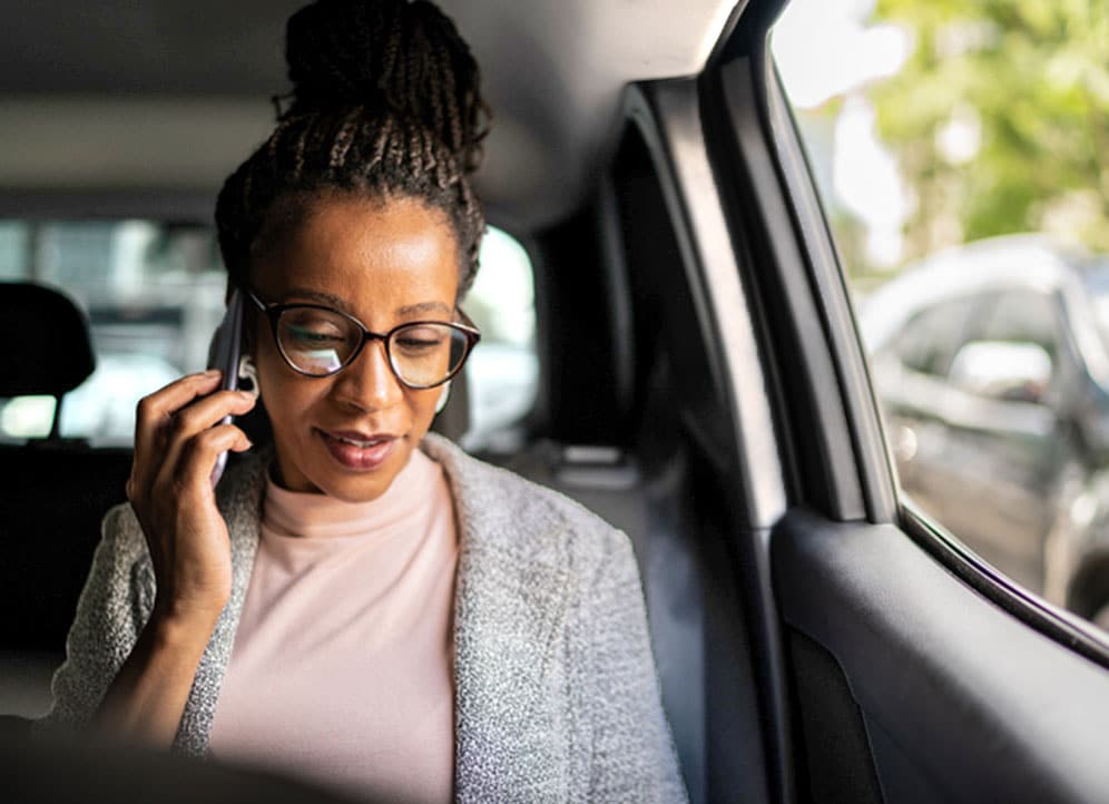 Realtor in car talking with client on phone