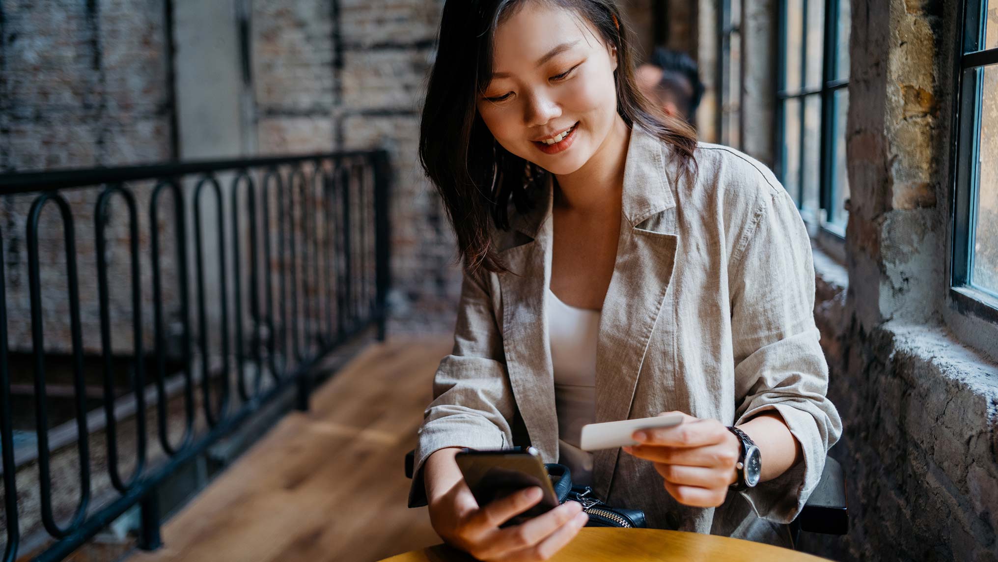 Woman at work lunch adding contact to phone