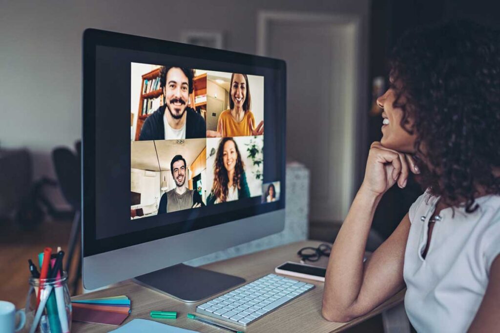 Woman looking at monitor in home office on conference call